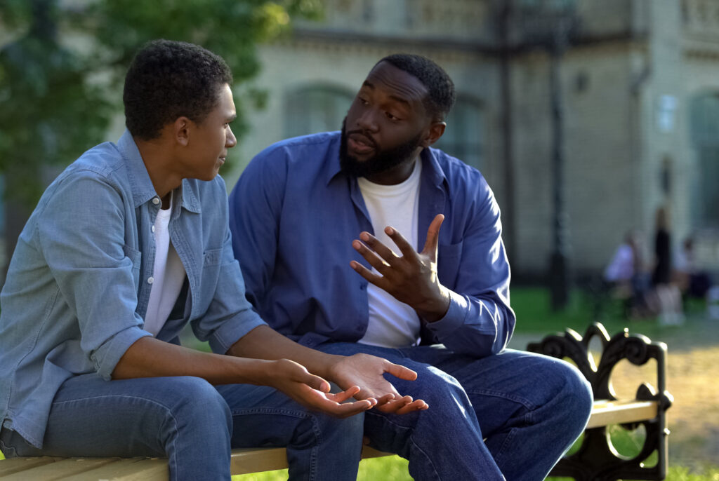 man talking with his son about getting drug addiction treatment in Alpharetta