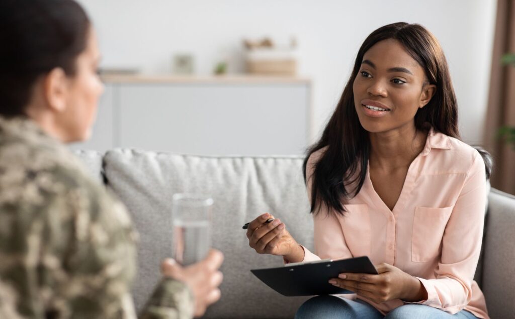 Therapist explaining to a veteran whether trauma therapy can make PTSD worse before it gets better.