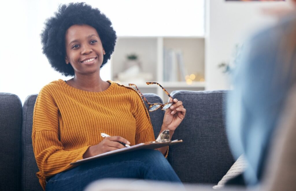 Therapist guiding a client through the decision, “Do I need PHP or can I start with IOP?”