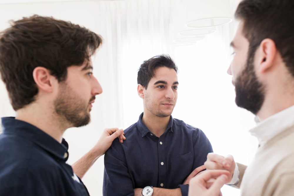 Male friends talking during a therapy session at a rehab in Fulton County, GA.