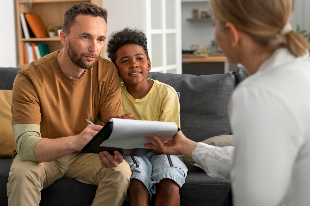 ather and son reviewing paperwork for a rehab that accepts Cigna in Alpharetta, GA.