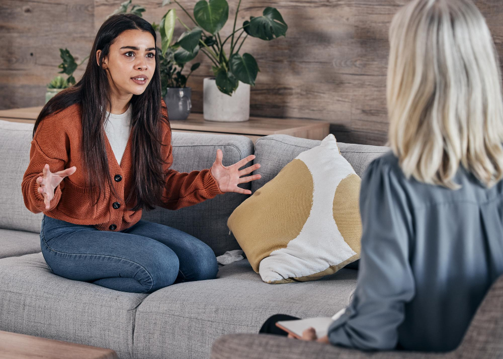 Therapist listening to a patient during young adult mental health treatment in Alpharetta, GA.