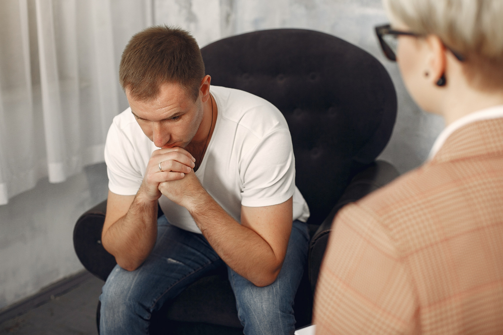 Man talking with a psychologist during a counseling session related to FMLA for drug rehab.