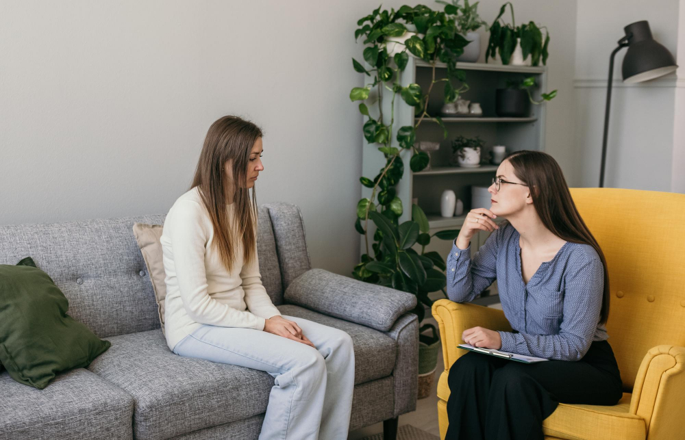 Frustrated young woman speaking with a psychologist during rehab for young adults in Alpharetta.