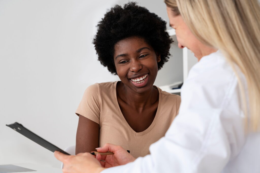 A woman discusses options for Aetna Rehab in Alpharetta, GA with her doctor.